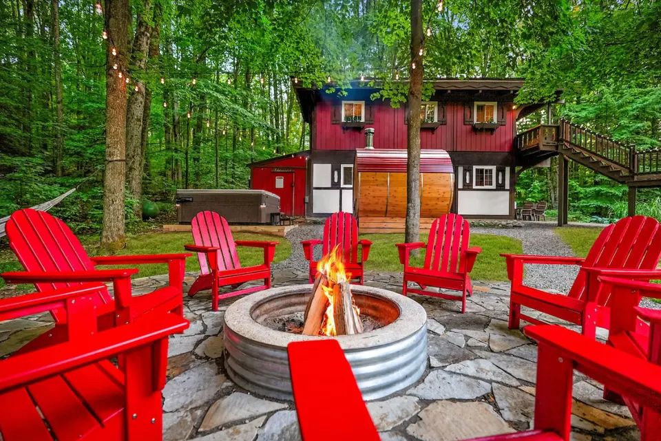 Cozy outdoor fire pit with Adirondack chairs surrounded by the forest